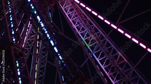 Close up ferris wheel moving abstract night time