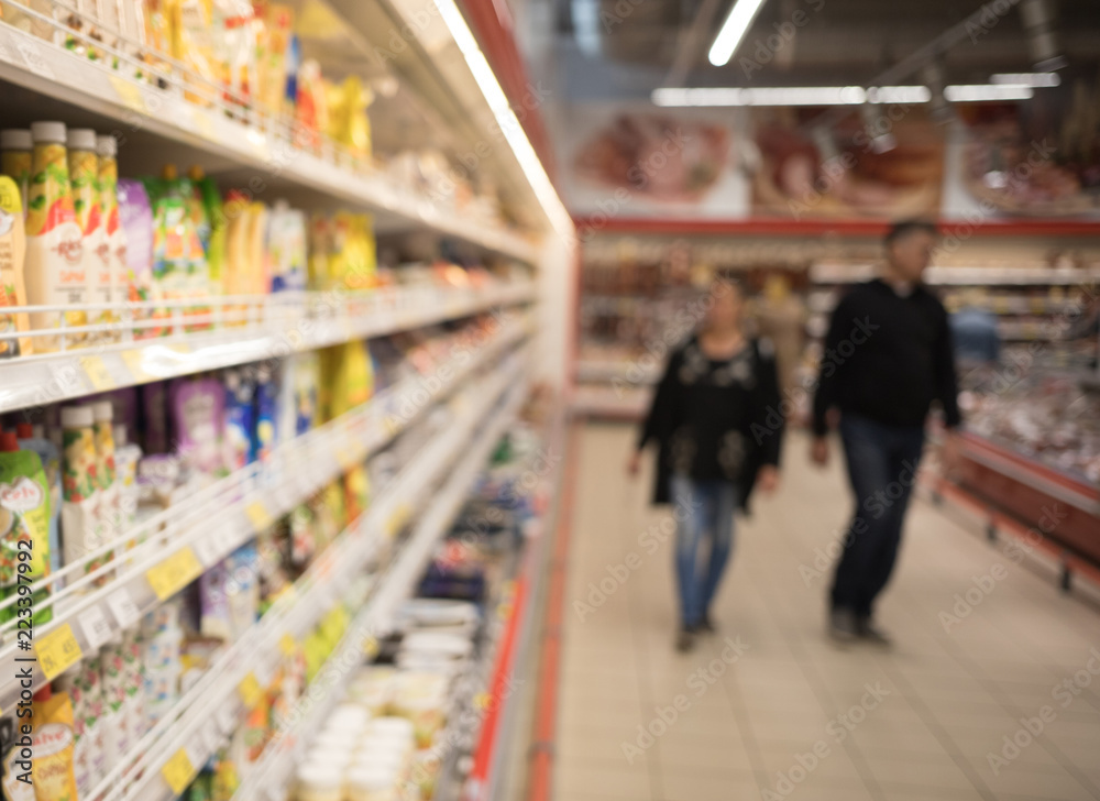 Abstract background blur photo of supermarket shopping. two people in the background