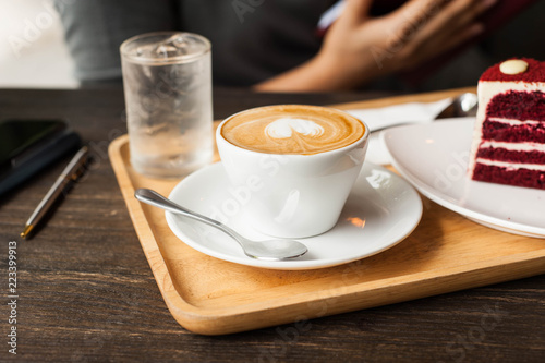 Cappuccino coffee in white cup lay on wooden plate,Relax time with coffee,Art of coffee