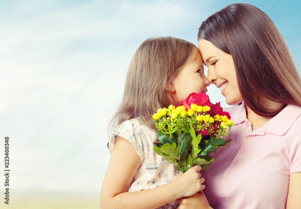 Portrait of happy mother and daughter holding