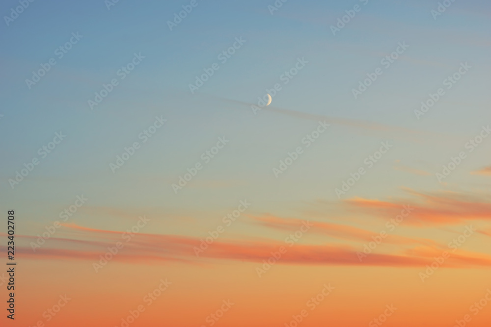 sunset half moon pink clouds.