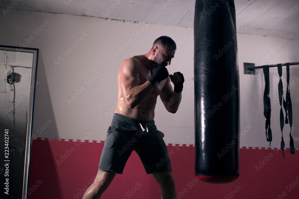 Young man boxing workout in an old building.
