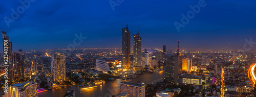 Beautiful aerial view Panorama day to night time lapse of Bangkok commercial district by the Chao Praya River, Thailand