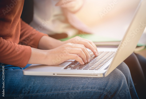 Young woman using laptop computer at outside office.