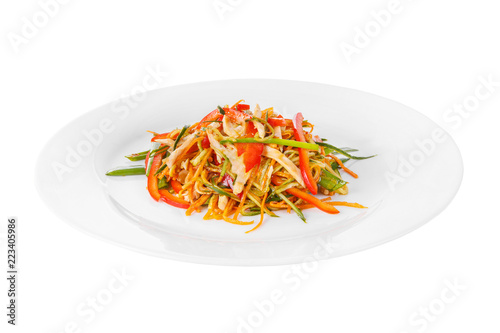 Salad with meat, chicken, pork, pepper, noodles, garlic arrows, green onions, tomato, carrots, zucchini, soy sauce on plate, white isolated background Side view. For the menu restaurant bar cafe