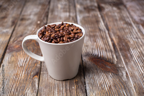 A cup filled with coffee beans