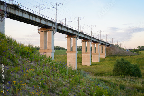 concrete railway bridge across a ravine with pillars