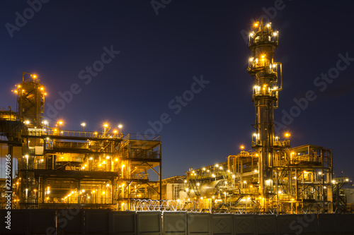 Night industrial landscape with bright lights of lanterns - fluid catalytic cracking unit (FCC) in a modern chemical factory. equipment of oil refinery.