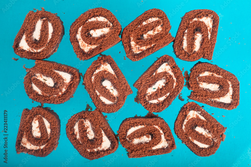 Chocolate roll on a turquoise background