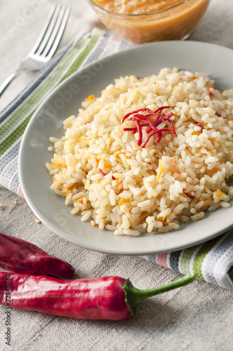 Photos Spicy parboiled rice with carrots, yellow zucchini and chilli peppers