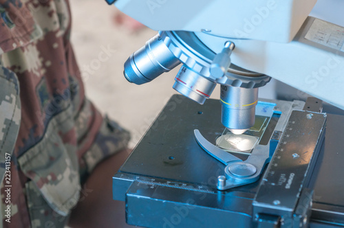 Scientist of Royal thai Army Medical working with a microscope in laboratory