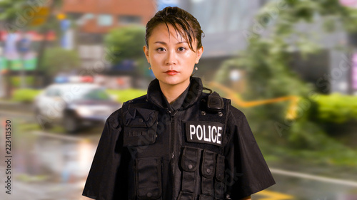 Enviromental portrait of Asian American Woman Police Officer at Crime scene