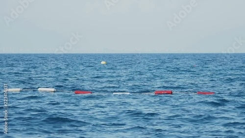 Buoys that limit the safe area for swimming, swinging on the waves. photo