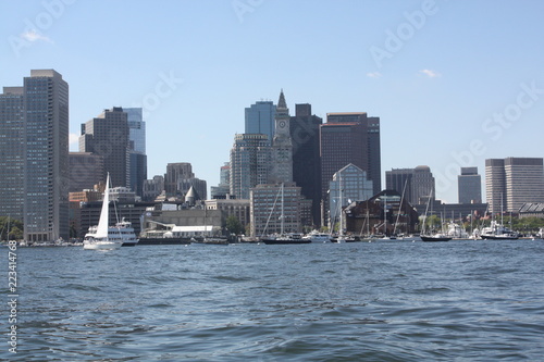 Boston Skyline Seen From the Harbor. 
The skyline of Boston as see from the middle of the Boston Harbor. The historical `Custom House Tower` is the pointed building with the clock on it. photo