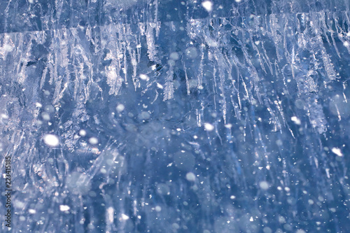 Texture of ice in winter. Pieces of frozen water on a street in 