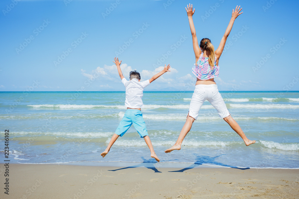 Adorable kids have fun on the beach.