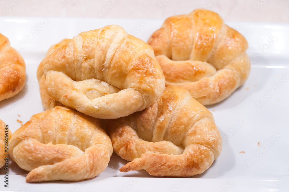 close up of croissants in white dish for breakfast in morning time