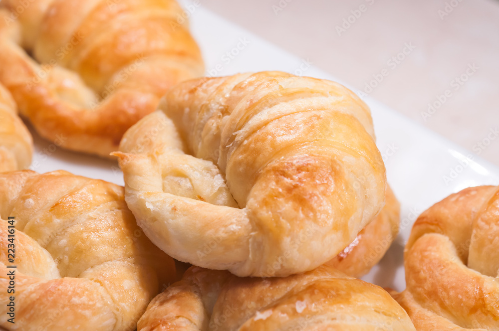 close up of croissants in white dish for breakfast in morning time