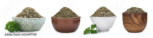 Set of bowls with dried parsley on white background
