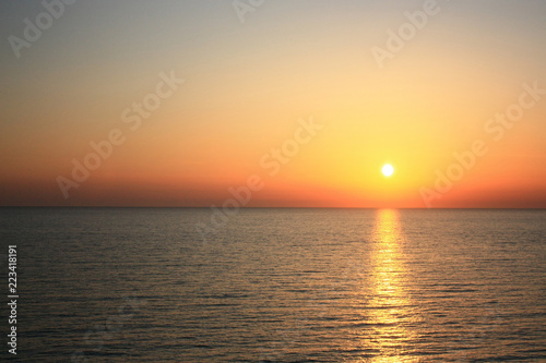 Sea sunset. Orange sun. Summer warm evening view from the cliffs to the sea. © Yevhen Kaplinskiy