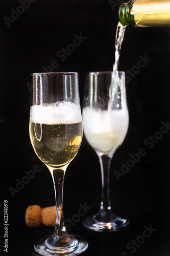 Party concept. Full glass of champagne with party lights background.