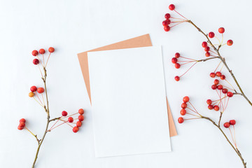 Mockup blank paper card and branch with small red apples