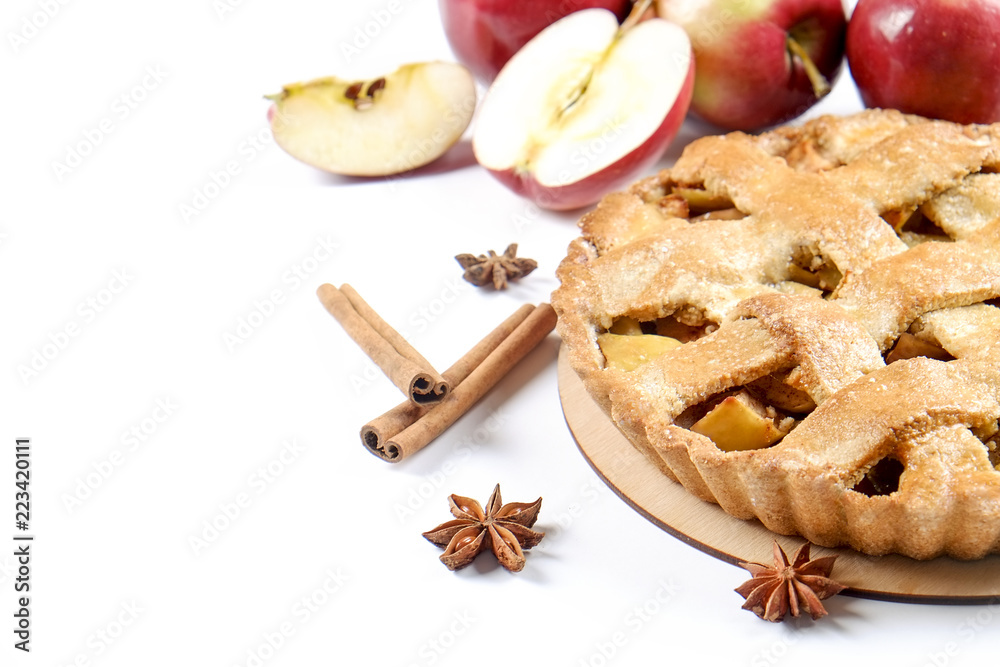 Traditional American Thanks Giving pie, whole & halved apples, cinnamon sticks, anise seeds. Homemade fruit tart baked to golden crust with ingredients. Close up, copy space, top view, background.