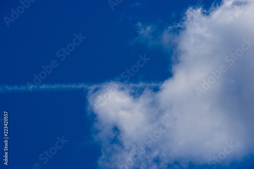 Summer clouds, airplane trail