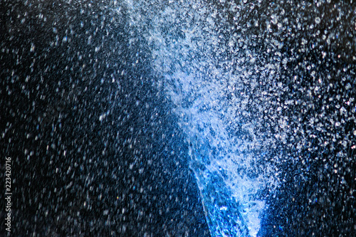 Illuminated water jets. Blue color