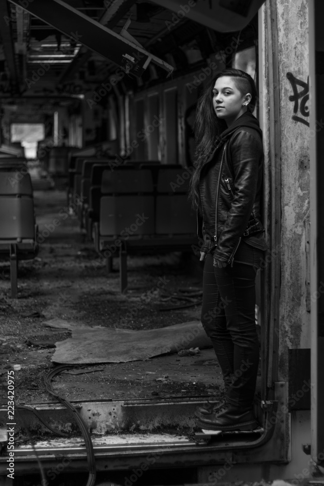 portrait Young woman with long grounge red hair posing in an abandoned place full of graffity black & white