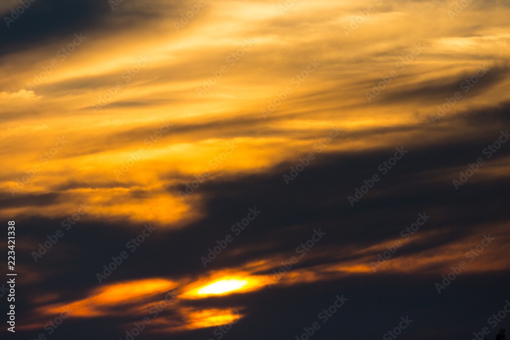sunset in dramatic orange sky with clouds