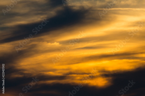 sunset in dramatic orange sky with clouds in twilight