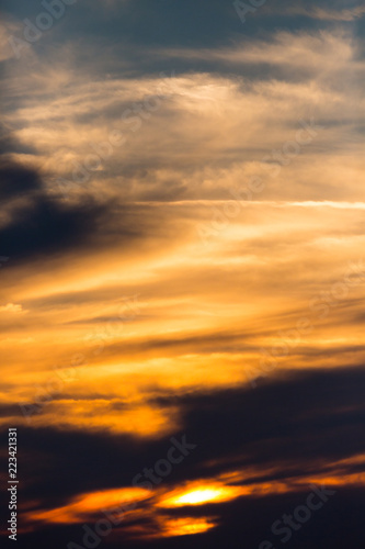 sunset in dramatic orange sky with clouds, blue sky