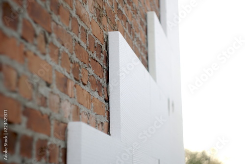 insulation of a brick wall with polystyrene white