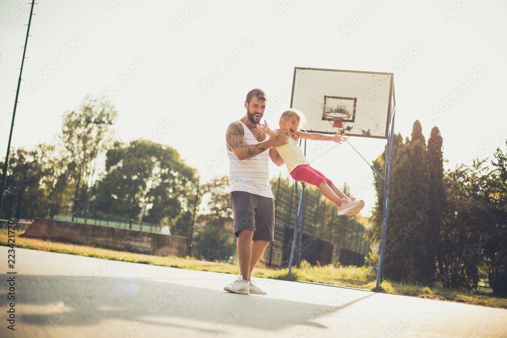 Happy father playing with his daughter.