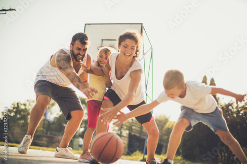 Family playing basketball together.