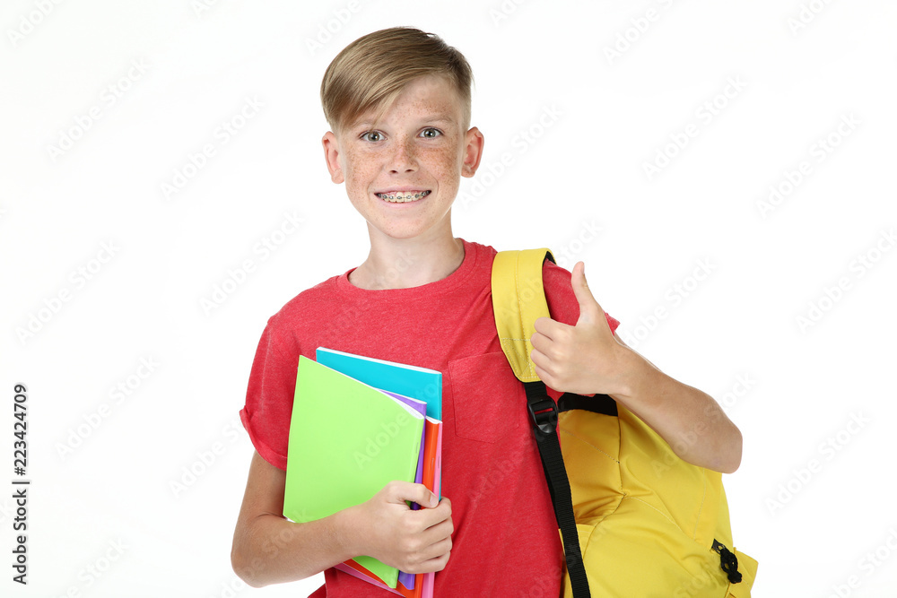 Young boy with notebooks and backpack on white background Young boy with notebooks and backpack on white background