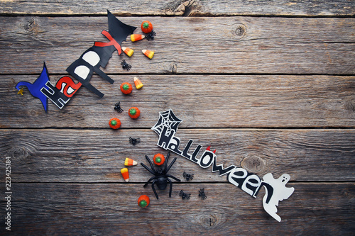 Halloween candy corns with spiders on grey wooden table