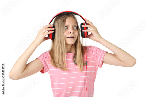 Beautiful young girl with headphones on white background