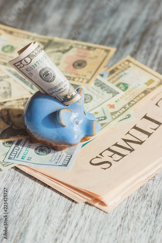 Piggy bank and American dollars, soft focus background
