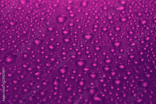 water drops on cherry color background texture