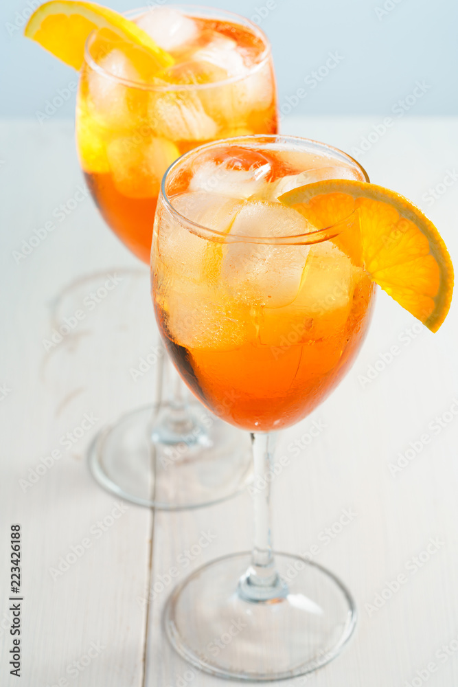 Aperol Spritz served with an orange slice in wine glasses. White background, high resolution Aperol Spritz served with an orange slice in wine glasses. White background, high resolution