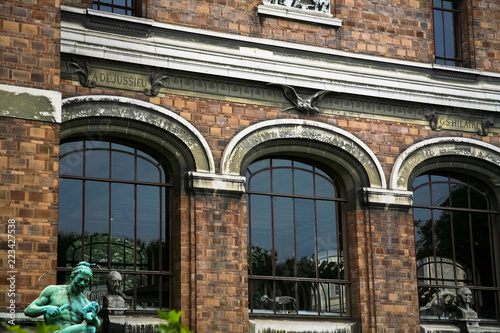 Dinosor building in Paris with statues photo