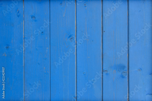 Vivid blue wooden background. Vertical boards painted. Dark blue pastel color.