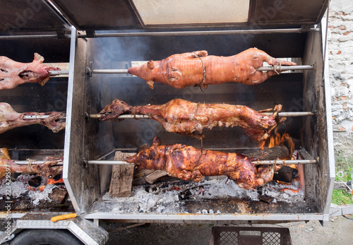 Complete fried piglets and lambs on skewers of mobile rotisserie
