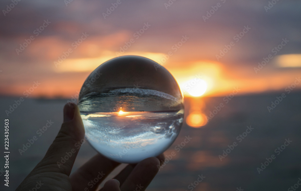 Bright Sunset Seascape with Boat on Horizon Captured in Glass Ball Bright Sunset Seascape with Boat on Horizon Captured in Glass Ball
