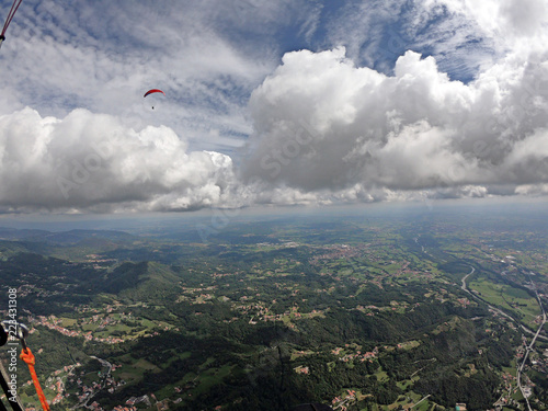 flying through the clouds in paraglide © ueuaphoto