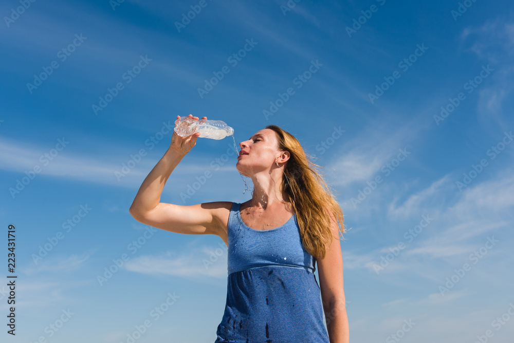 Blondy thirsty girl in blue top enjoy drinking Blondy thirsty girl in blue top enjoy drinking