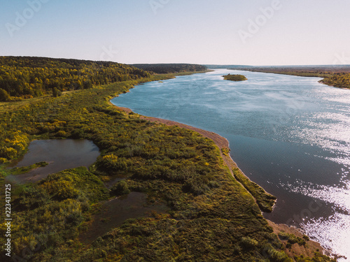 Forest river. Autumn landscape. Taiga forest from aerial view. Vasyugan swamp. Rural landscape