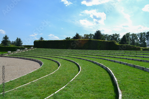 Green grass amphitheater in Europe under the clouds